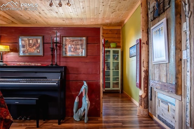 misc room featuring hardwood / wood-style flooring, wood ceiling, and wood walls