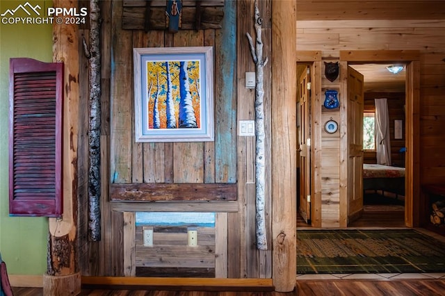 interior space featuring wooden walls and hardwood / wood-style floors