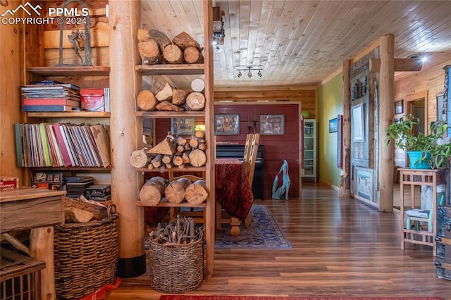 interior space with wood ceiling, wood walls, and hardwood / wood-style floors