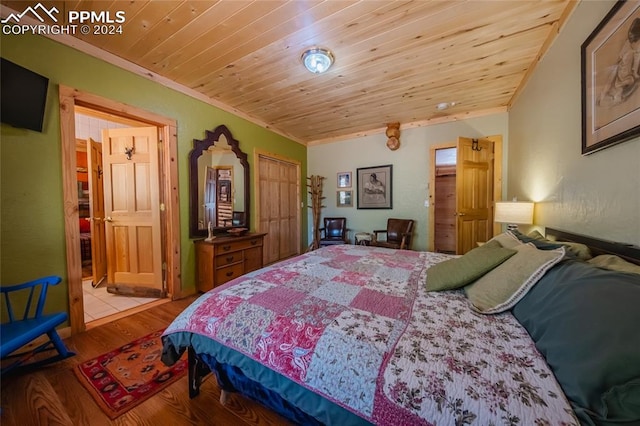 bedroom with ornamental molding, light hardwood / wood-style floors, and wooden ceiling