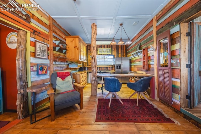 interior space featuring light wood-type flooring and wooden walls