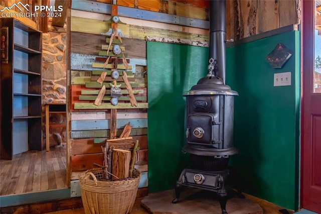 sitting room featuring wood-type flooring and a wood stove