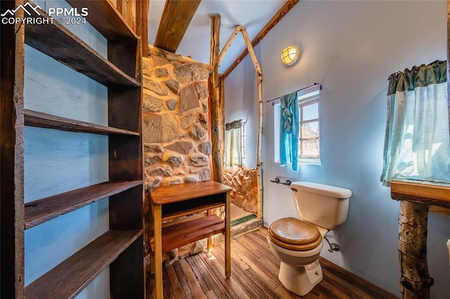 bathroom featuring wood-type flooring and toilet