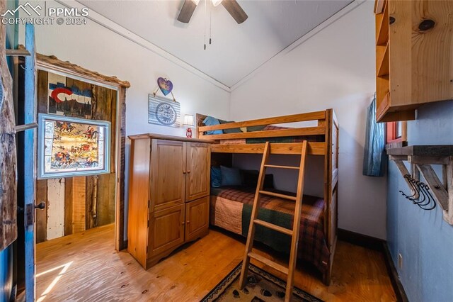 bedroom with lofted ceiling, hardwood / wood-style floors, and ceiling fan