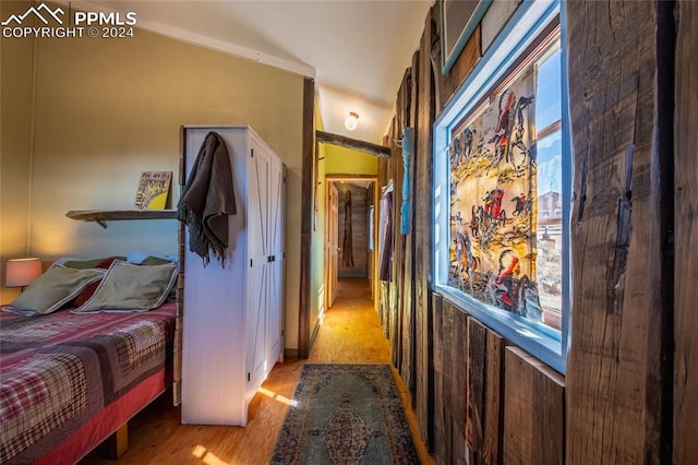 bedroom with light hardwood / wood-style flooring and lofted ceiling