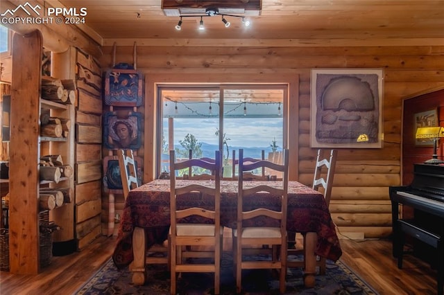 dining space with wooden ceiling, wood-type flooring, rustic walls, and a wealth of natural light