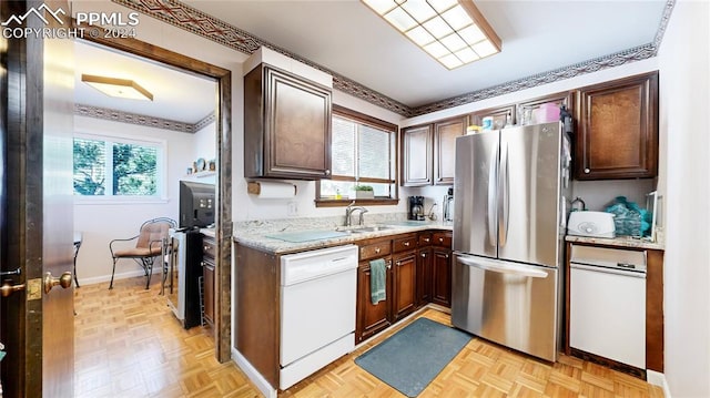 kitchen featuring white dishwasher, stainless steel fridge, light parquet flooring, and a healthy amount of sunlight