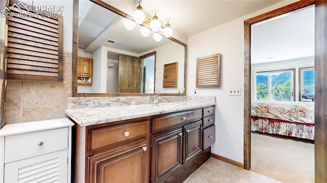 bathroom featuring vanity, tile patterned flooring, and a notable chandelier