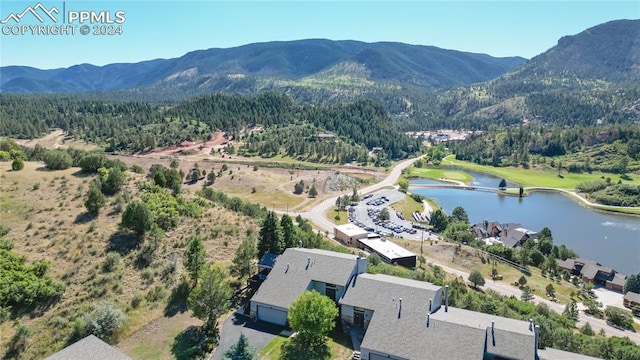 birds eye view of property with a water and mountain view