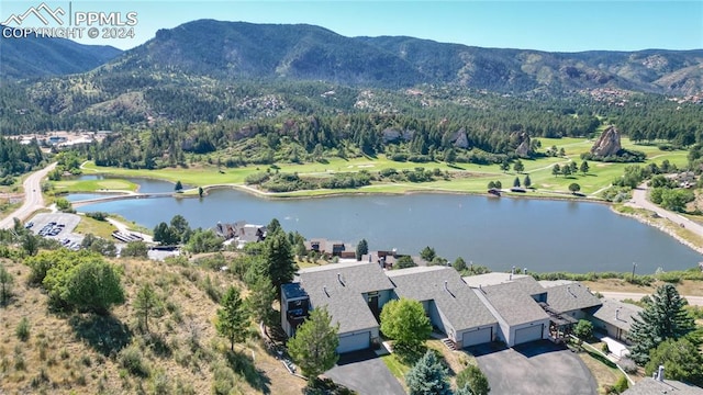 birds eye view of property with a water and mountain view