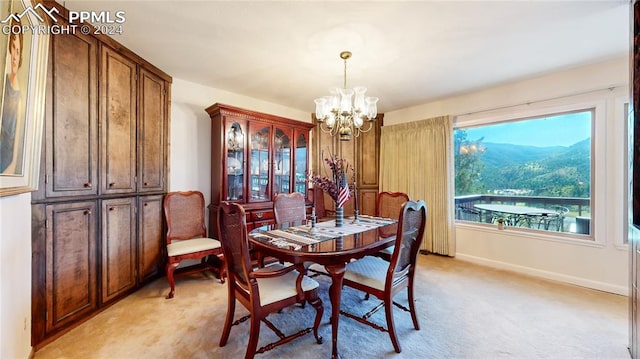 carpeted dining space with an inviting chandelier and a mountain view