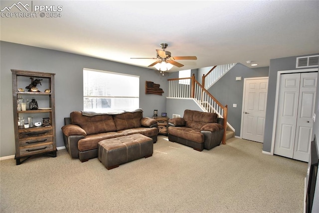 living room with ceiling fan and light colored carpet