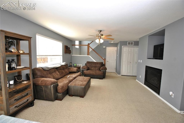 carpeted living room featuring ceiling fan