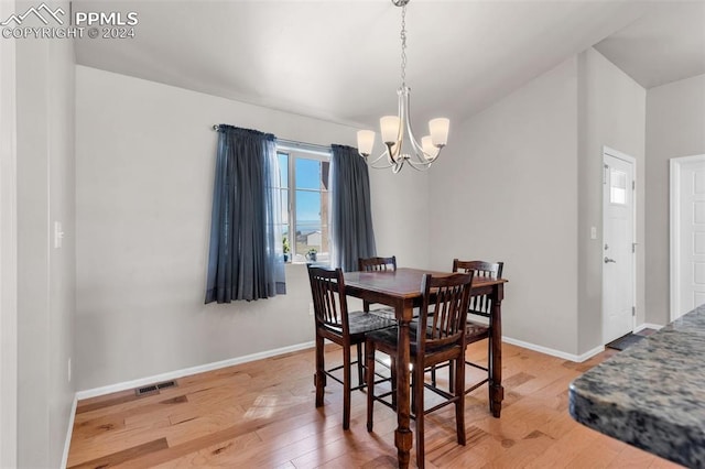 dining room featuring a notable chandelier and light hardwood / wood-style floors