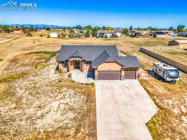 view of front of property with a mountain view and a garage