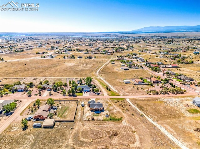 drone / aerial view featuring a mountain view and a rural view