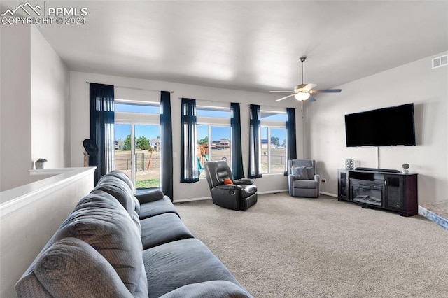 living room featuring light carpet and ceiling fan