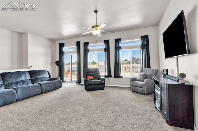 living room with ceiling fan, light colored carpet, and a wealth of natural light