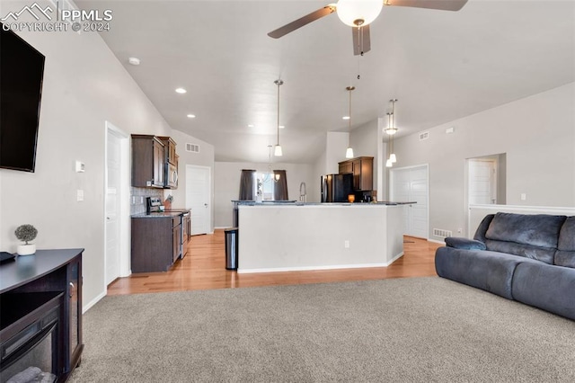 living room with ceiling fan, light hardwood / wood-style flooring, and high vaulted ceiling