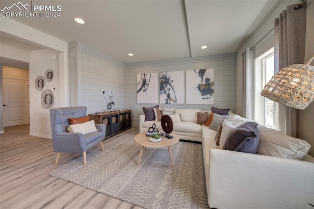 living room with wood walls and wood-type flooring