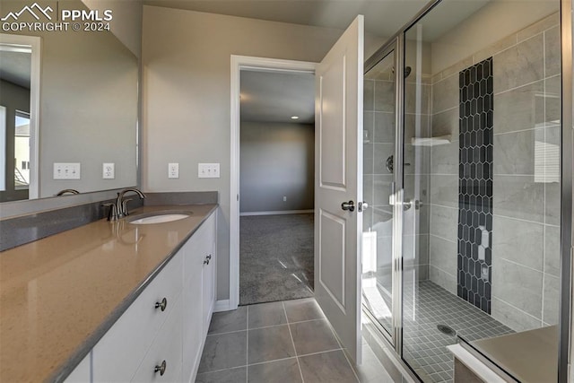 bathroom featuring walk in shower, vanity, and tile patterned floors