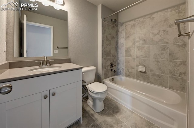 full bathroom featuring tiled shower / bath combo, vanity, and toilet