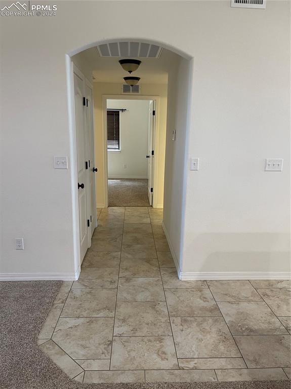 corridor featuring carpet flooring