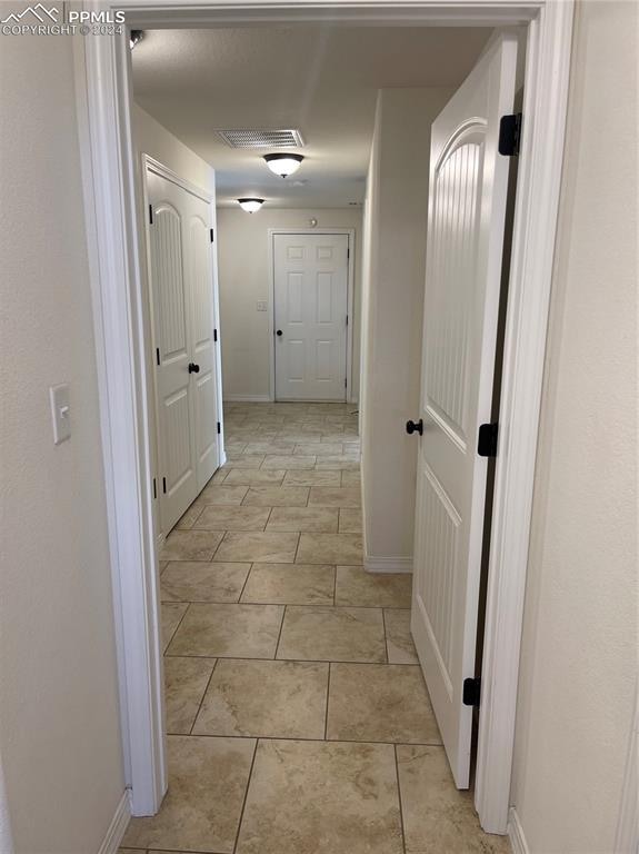 hallway featuring light tile patterned floors