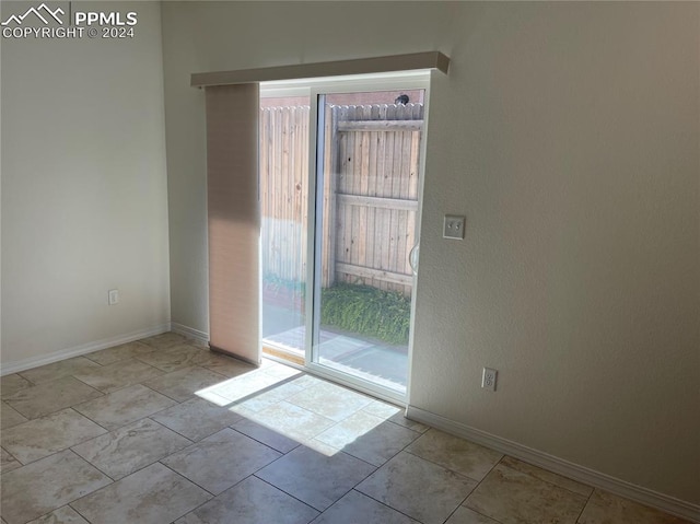 unfurnished room featuring light tile patterned floors