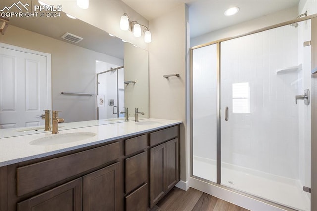 bathroom featuring vanity, hardwood / wood-style floors, and an enclosed shower