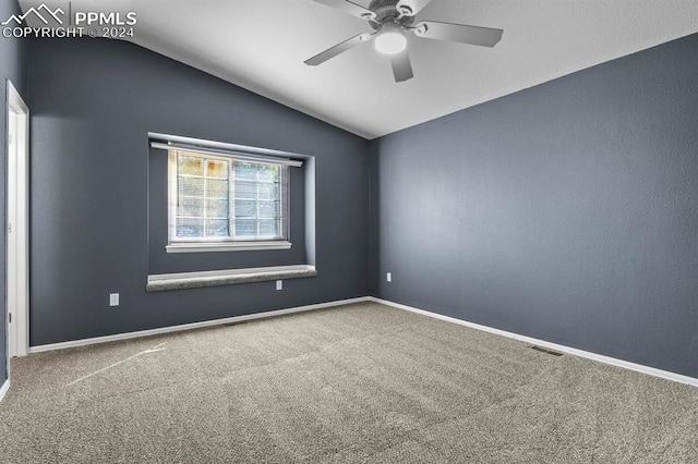 carpeted spare room with vaulted ceiling and ceiling fan