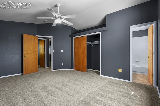 unfurnished bedroom featuring ceiling fan, lofted ceiling, connected bathroom, a closet, and carpet floors