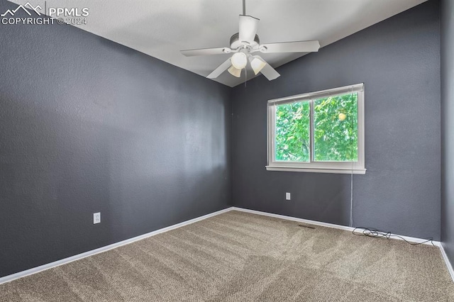 carpeted empty room featuring lofted ceiling and ceiling fan