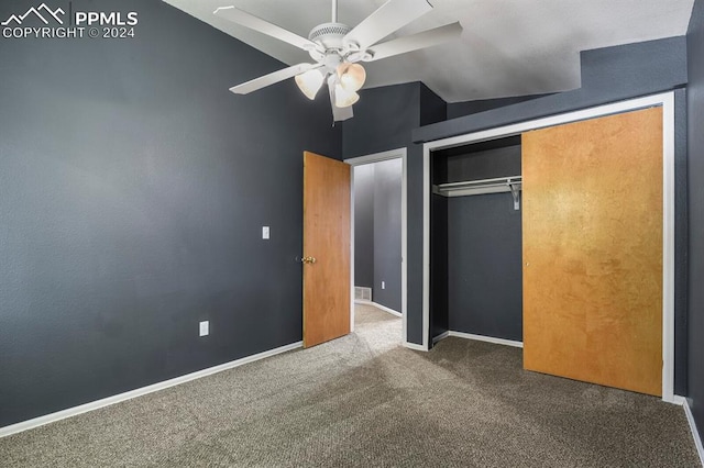 unfurnished bedroom with lofted ceiling, carpet flooring, ceiling fan, and a closet