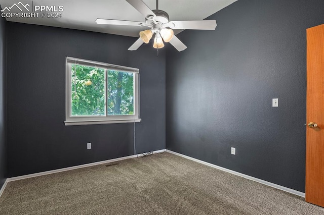 carpeted spare room with ceiling fan