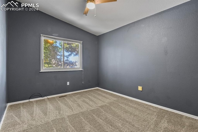 empty room with carpet floors, lofted ceiling, and ceiling fan