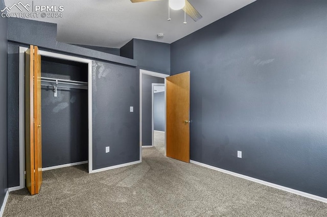 unfurnished bedroom with carpet, ceiling fan, and a closet