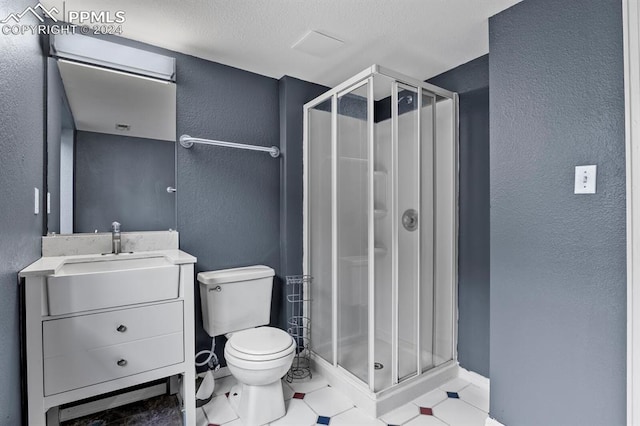 bathroom featuring vanity, tile patterned flooring, toilet, and a shower with door