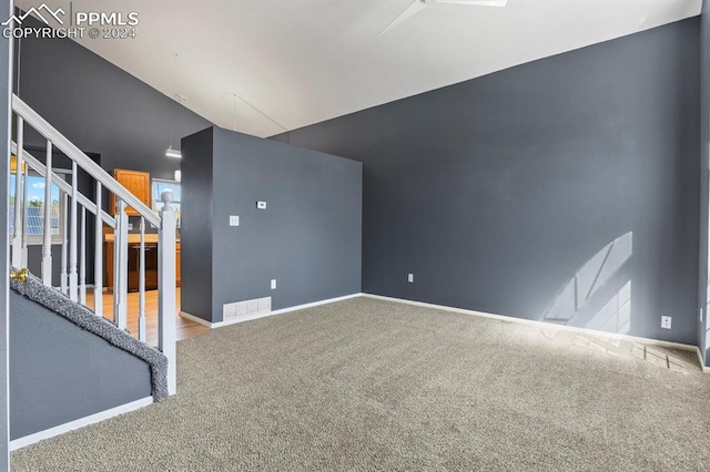 interior space featuring vaulted ceiling and carpet floors