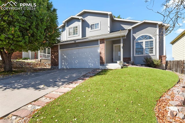 view of property with a front yard and a garage