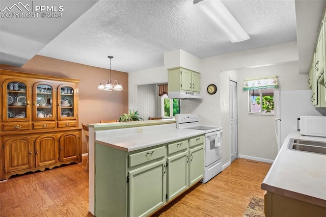 kitchen featuring a wealth of natural light, white appliances, and light hardwood / wood-style floors