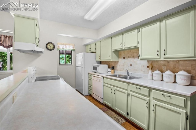 kitchen with green cabinets, sink, white appliances, and decorative backsplash