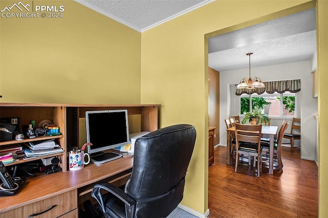 office space with a textured ceiling, crown molding, dark hardwood / wood-style floors, and a notable chandelier