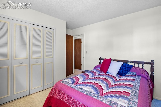 bedroom with a textured ceiling and a closet