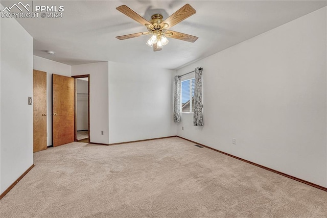 unfurnished bedroom featuring ceiling fan and light colored carpet