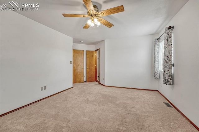 carpeted empty room with ceiling fan