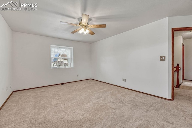 carpeted empty room with ceiling fan