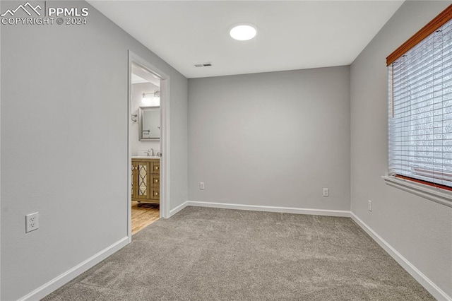 carpeted spare room with sink