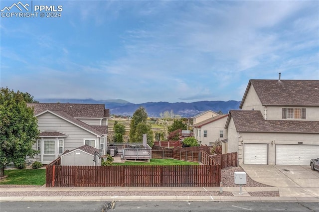 view of front property featuring a mountain view and a garage