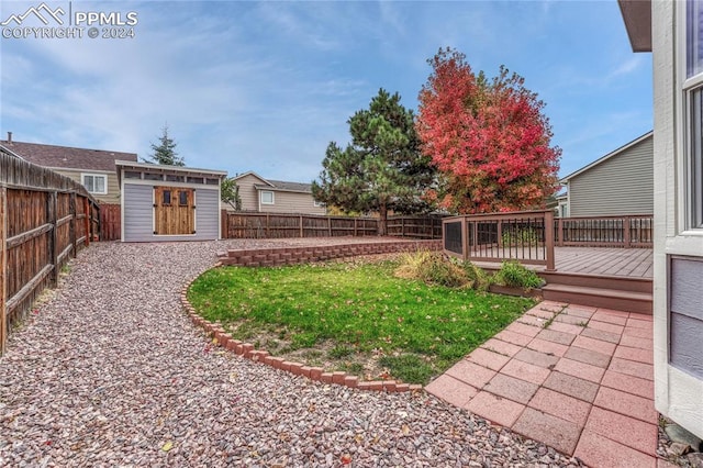 view of yard featuring a shed and a deck